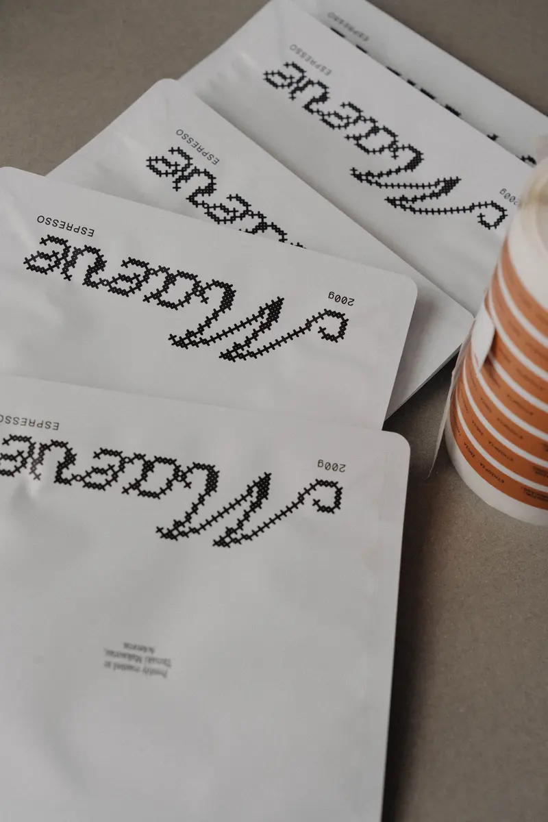 Maeve espresso bags lined up with a striped cup