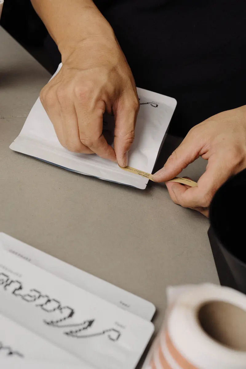 Hand-packing coffee bags for orders