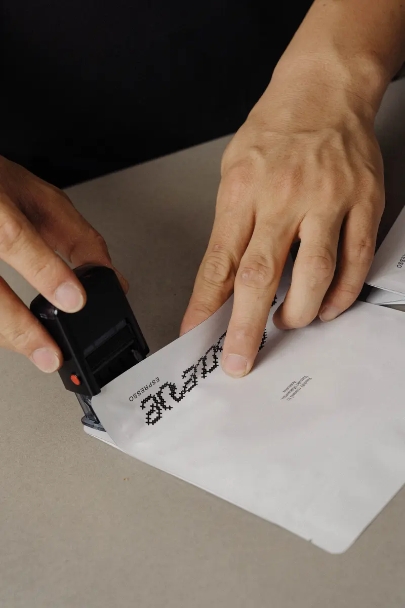 Stamping the Maeve brand on a bag